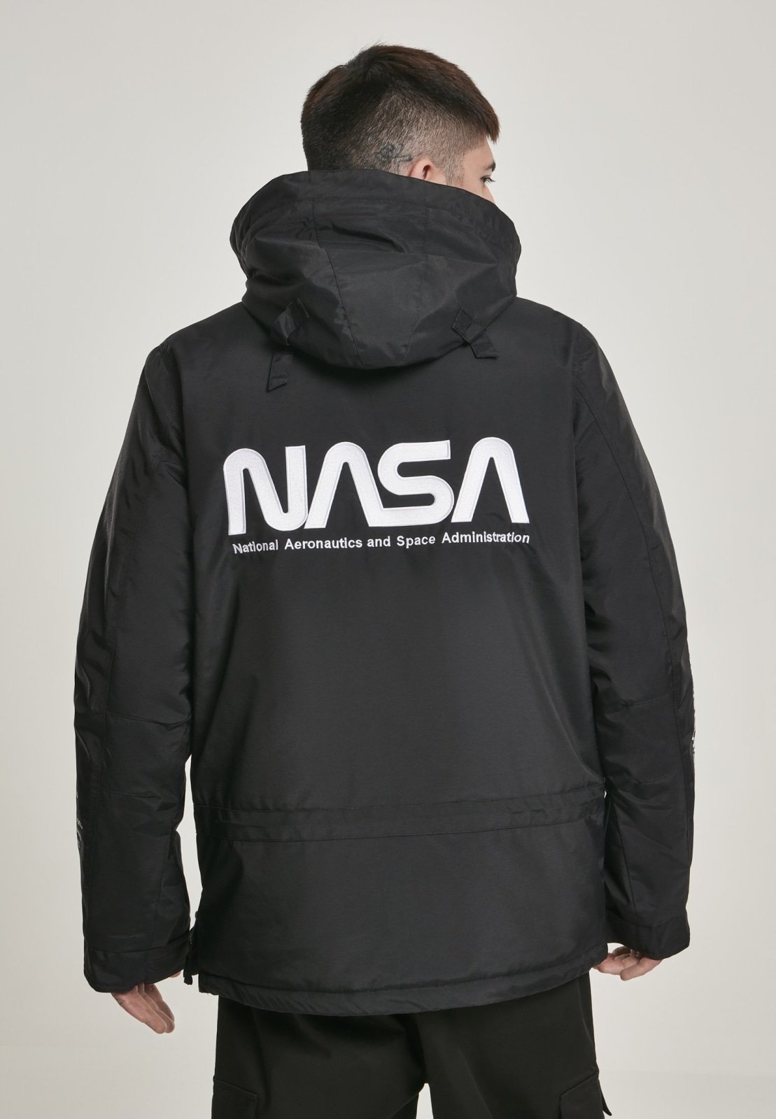 A stylish black windbreaker featuring NASA branding and a USA flag patch, designed with multiple pockets and a unique adjustable hood.