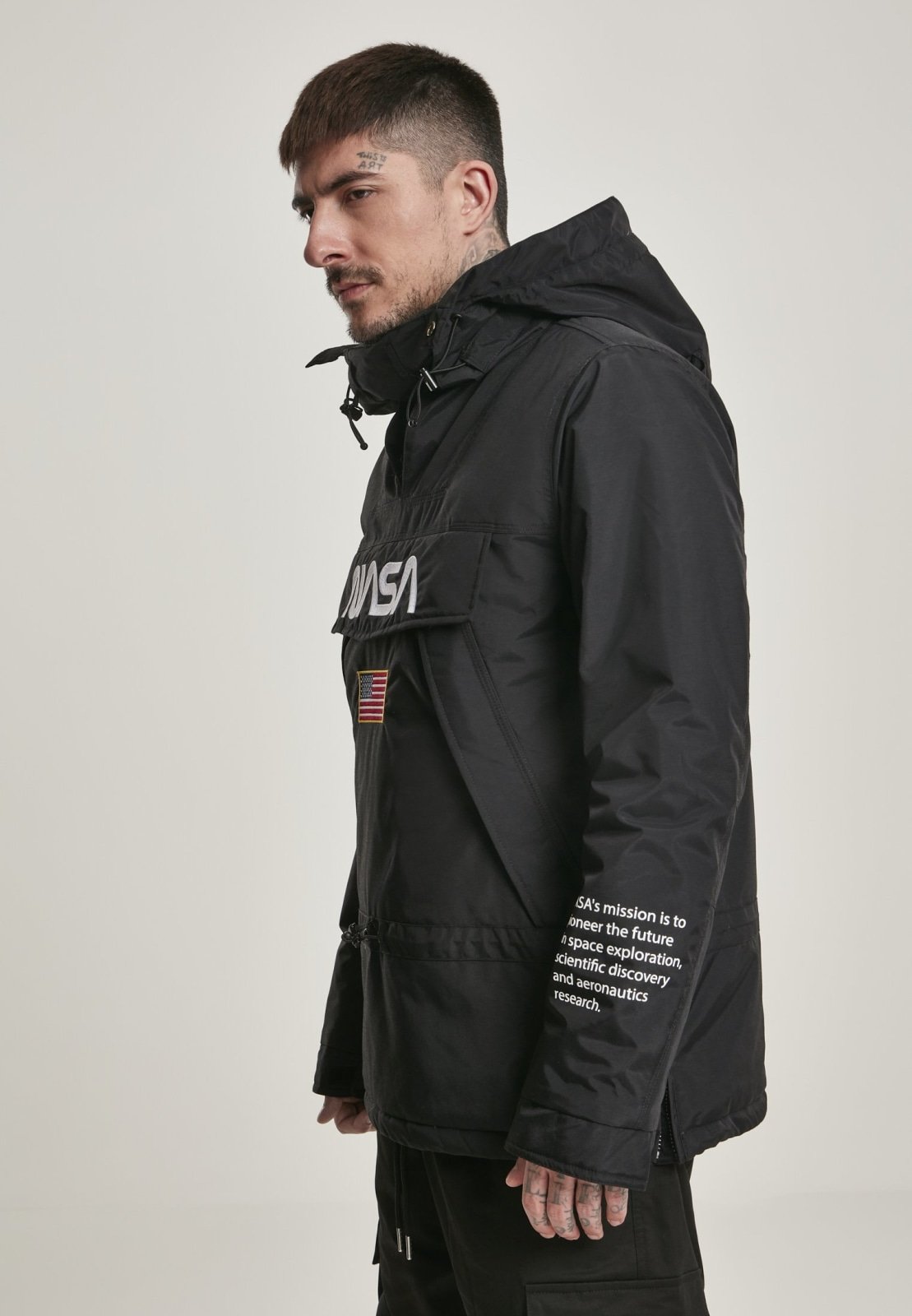 A stylish black windbreaker featuring NASA branding and a USA flag patch, designed with multiple pockets and a unique adjustable hood.