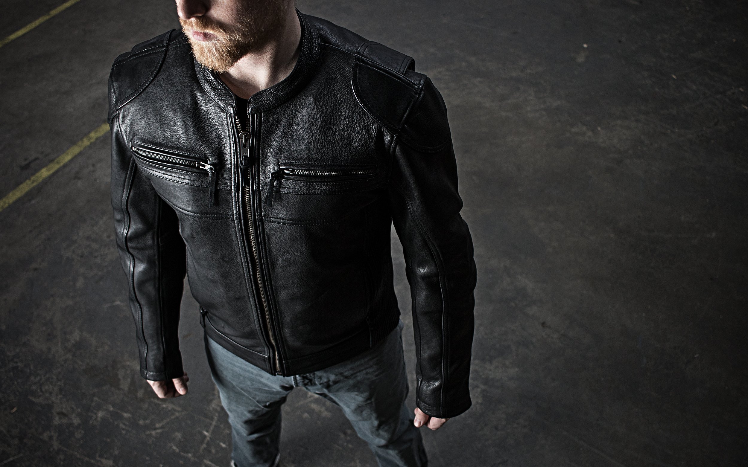 Nemesis Men's Leather Motorcycle Jacket made from premium cowhide, featuring a banded collar, zippered pockets, and padded details.