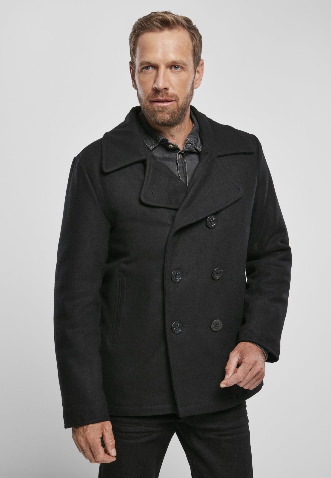 Chic Pea Coat in classic uniform style, featuring a wool-polyester blend, perfect for transitional weather, styled with jeans and leather shoes.