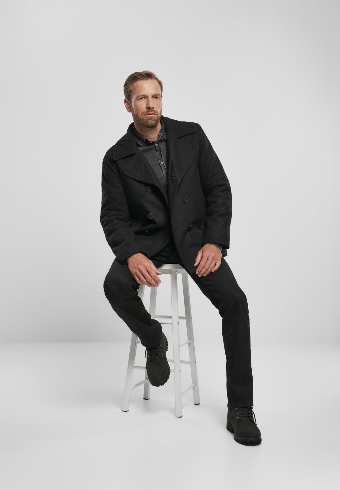 Chic Pea Coat in classic uniform style, featuring a wool-polyester blend, perfect for transitional weather, styled with jeans and leather shoes.