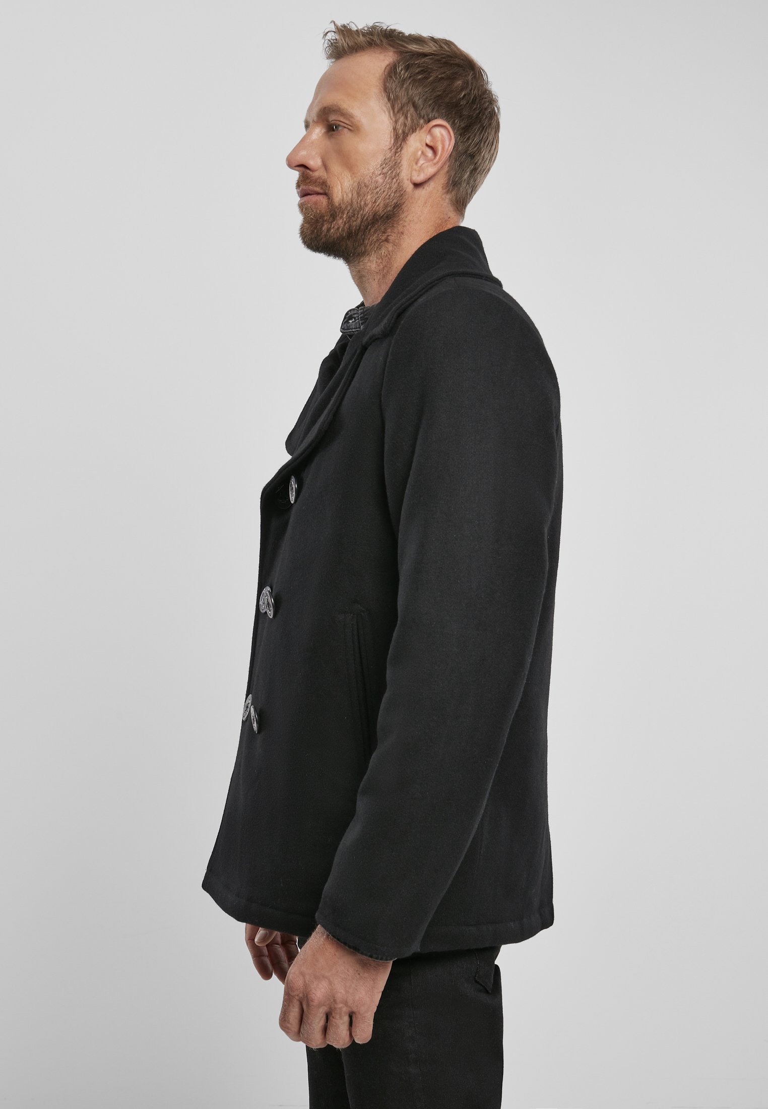 Chic Pea Coat in classic uniform style, featuring a wool-polyester blend, perfect for transitional weather, styled with jeans and leather shoes.