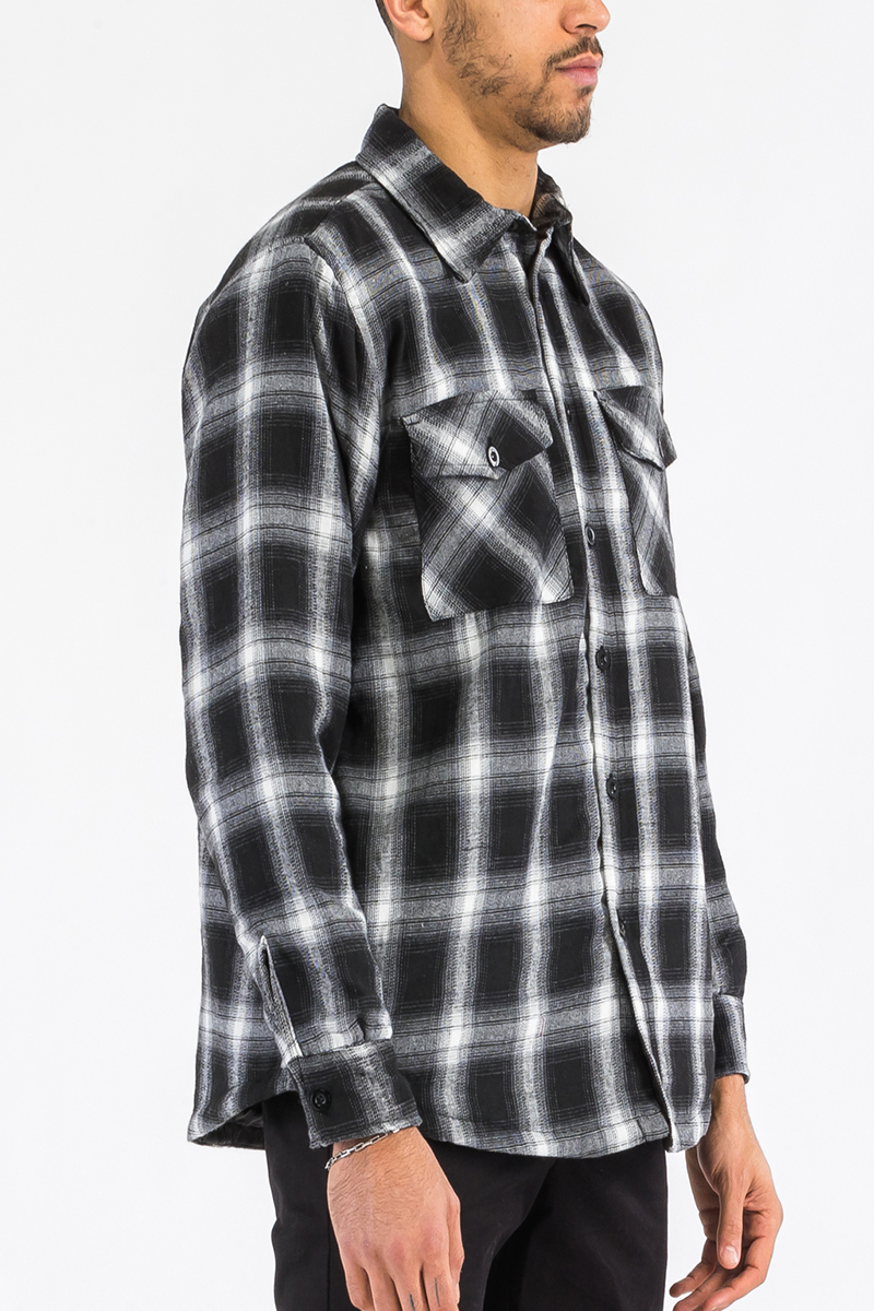 A stylish Quilted Flannel Shirt featuring a button closure, quilted polyester lining, and standard side pockets, perfect for layering.