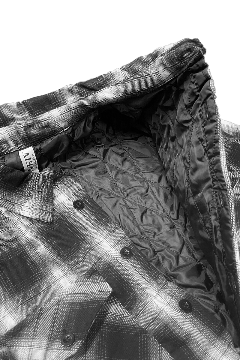 A stylish Quilted Flannel Shirt featuring a button closure, quilted polyester lining, and standard side pockets, perfect for layering.