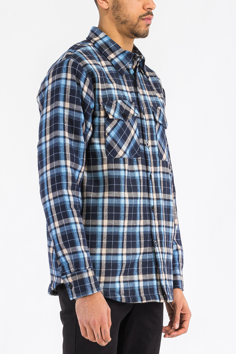 A stylish Quilted Flannel Shirt featuring a button closure, cozy quilted lining, and side pockets, perfect for layering and casual wear.