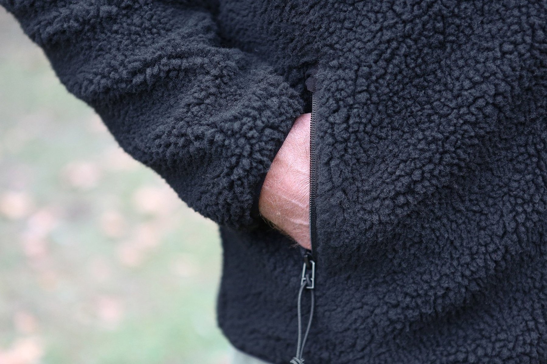 A cozy Teddyfleece Jacket featuring a deep pile fleece exterior, high stand-up collar, and multiple zippered pockets for convenience.