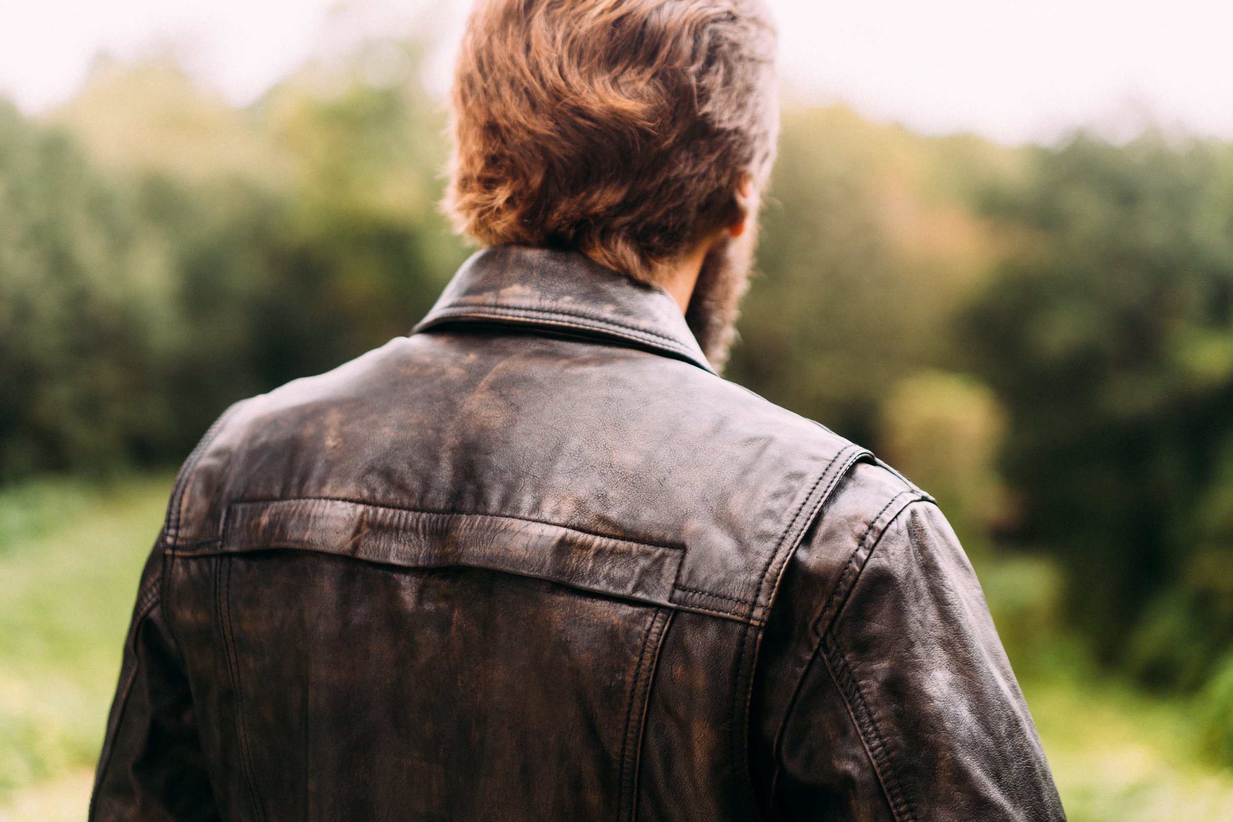 Villain Men's Leather Motorcycle Jacket featuring a stylish scooter design with multiple pockets and a banded collar.