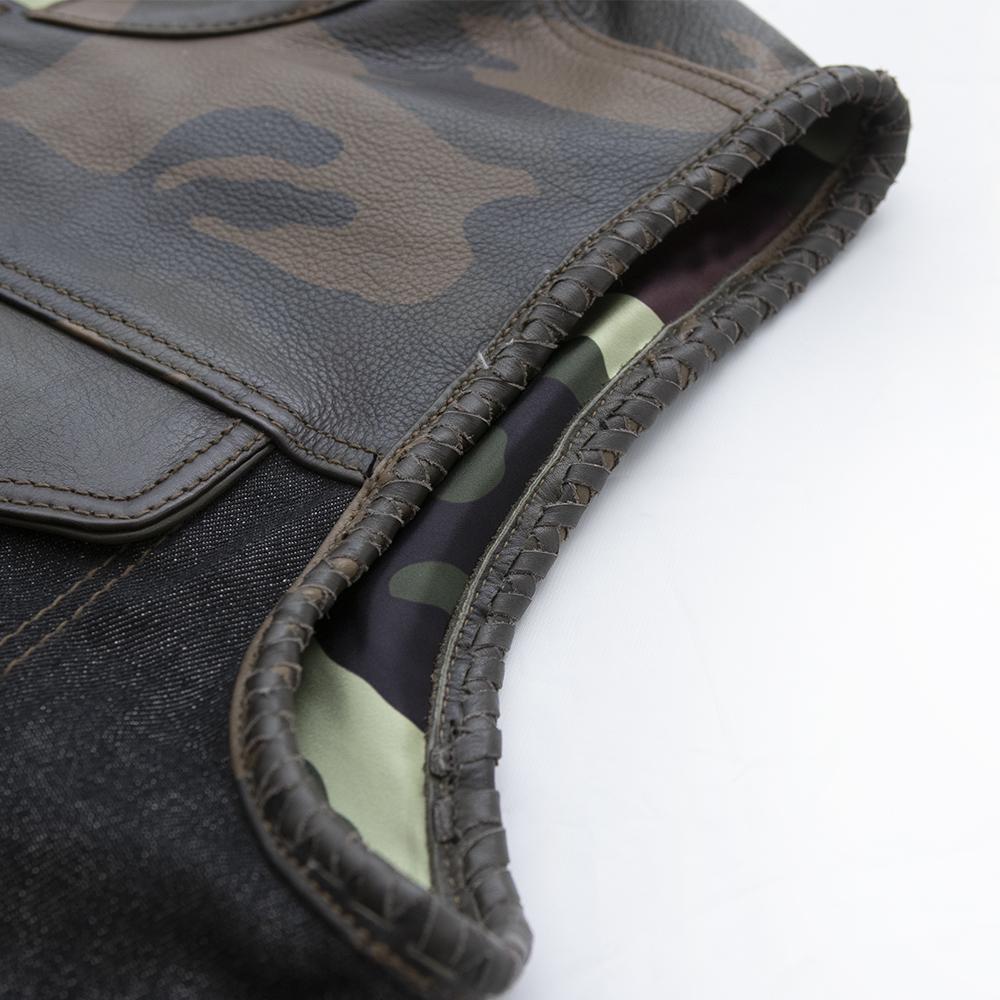 Woodsman jacket featuring woodland camo accents, denim bottom, and braided leather armholes.