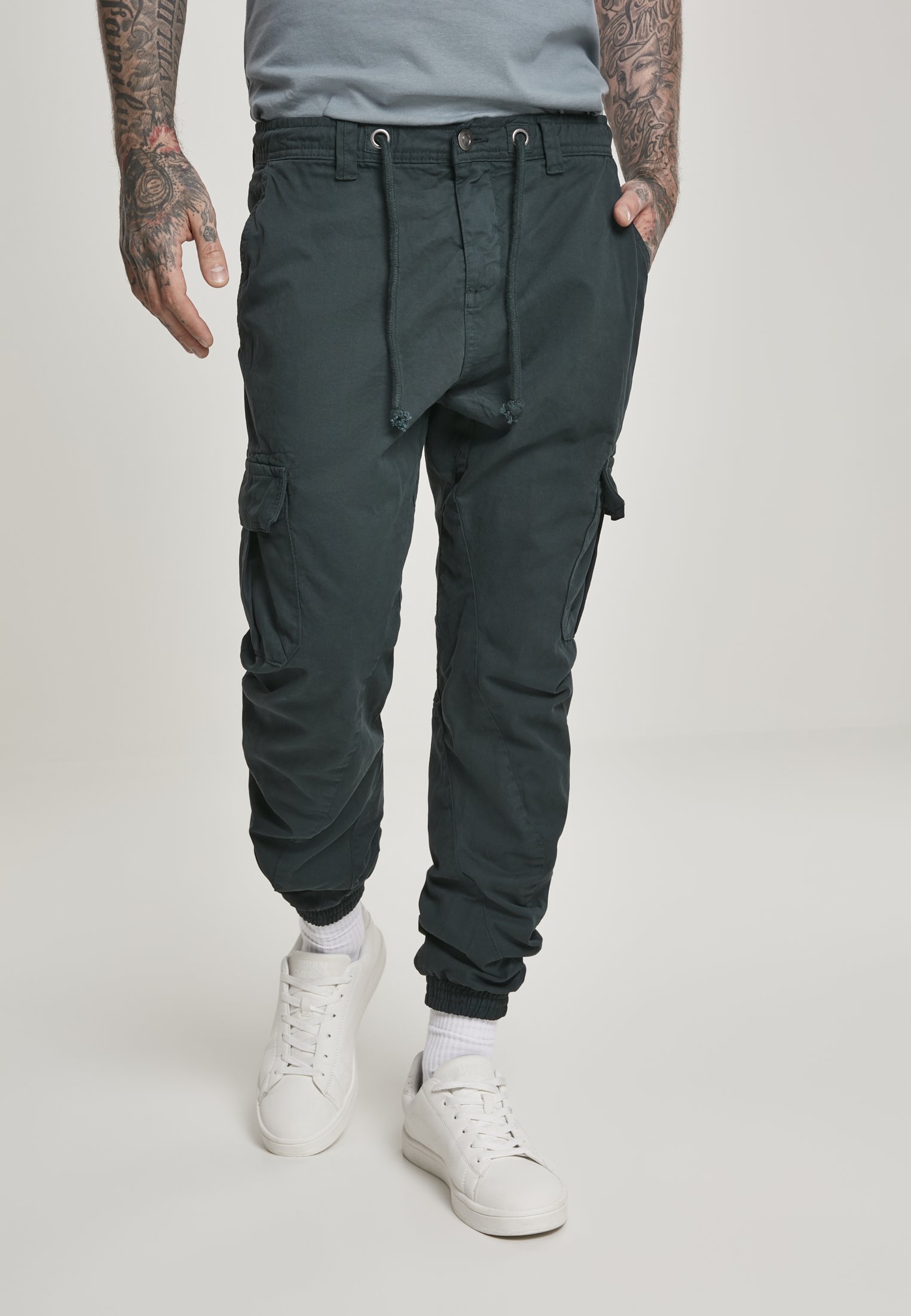 A pair of stylish cargo jogging pants made from 100% cotton, featuring multiple pockets and an elastic waistband for comfort.