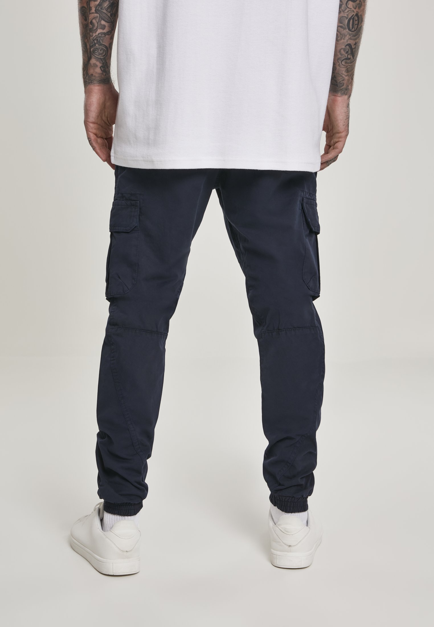 A pair of stylish cargo jogging pants made from 100% cotton, featuring multiple pockets and an elastic waistband for comfort.