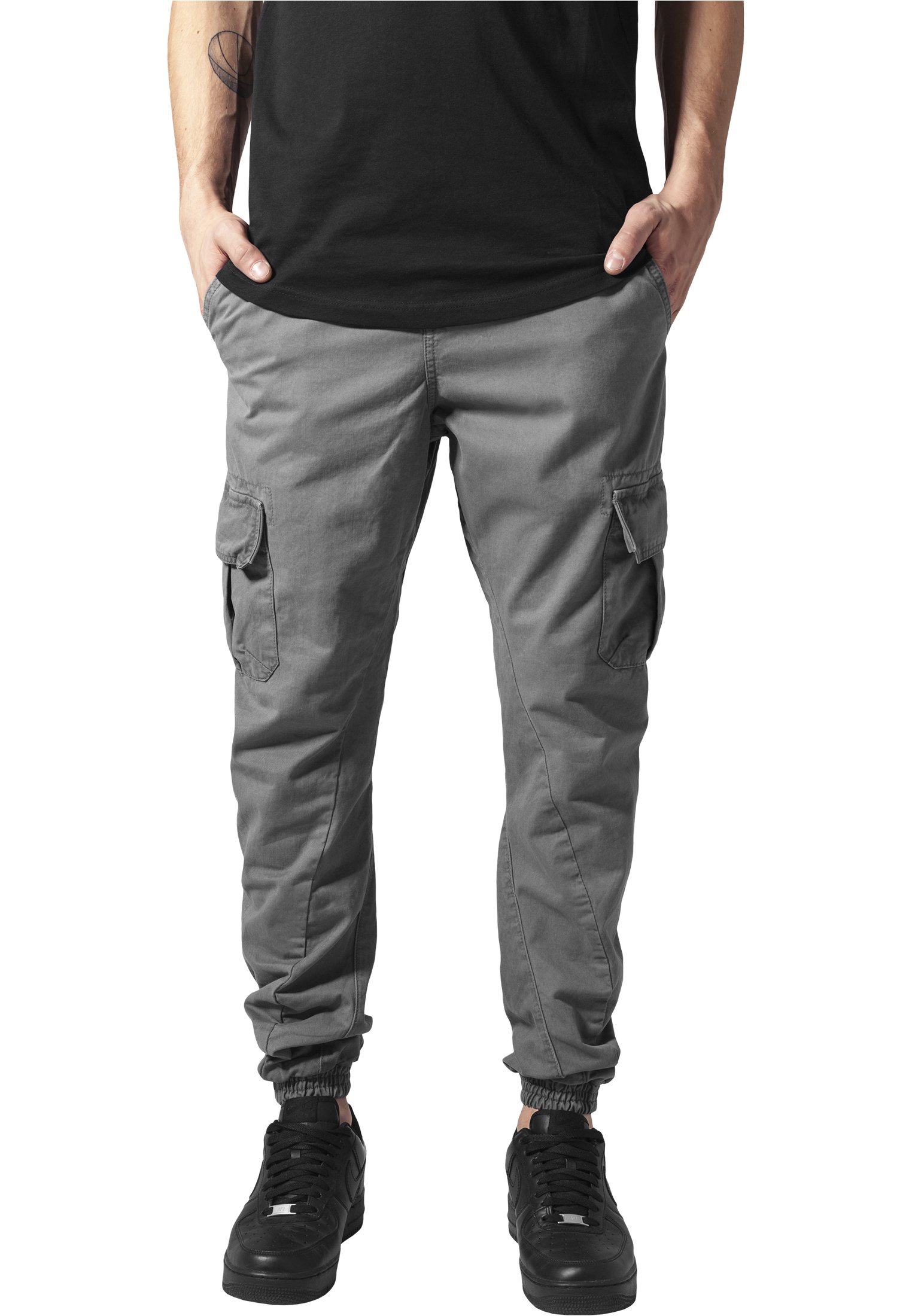 A pair of stylish cargo jogging pants made from 100% cotton, featuring multiple pockets and an elastic waistband for comfort.