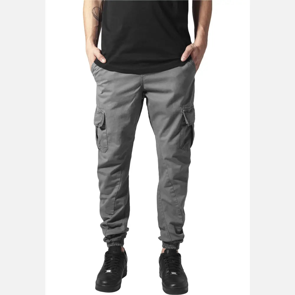 A pair of stylish cargo jogging pants made from 100% cotton, featuring multiple pockets and an elastic waistband for comfort.