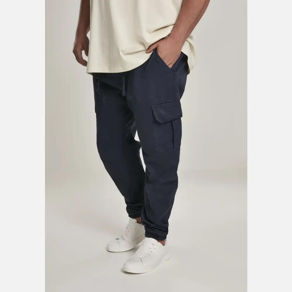 A pair of stylish cargo jogging pants made from 100% cotton, featuring multiple pockets and an elastic waistband for comfort.