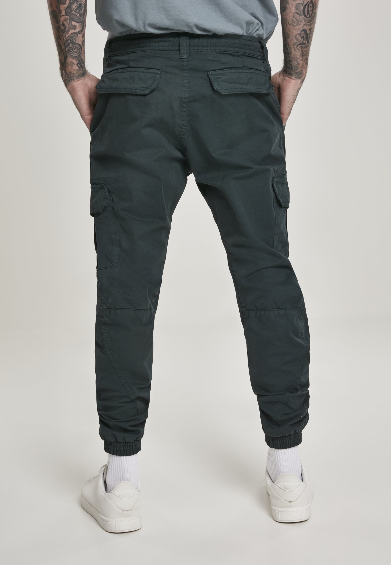 A pair of stylish cargo jogging pants made from 100% cotton, featuring multiple pockets and an elastic waistband for comfort.