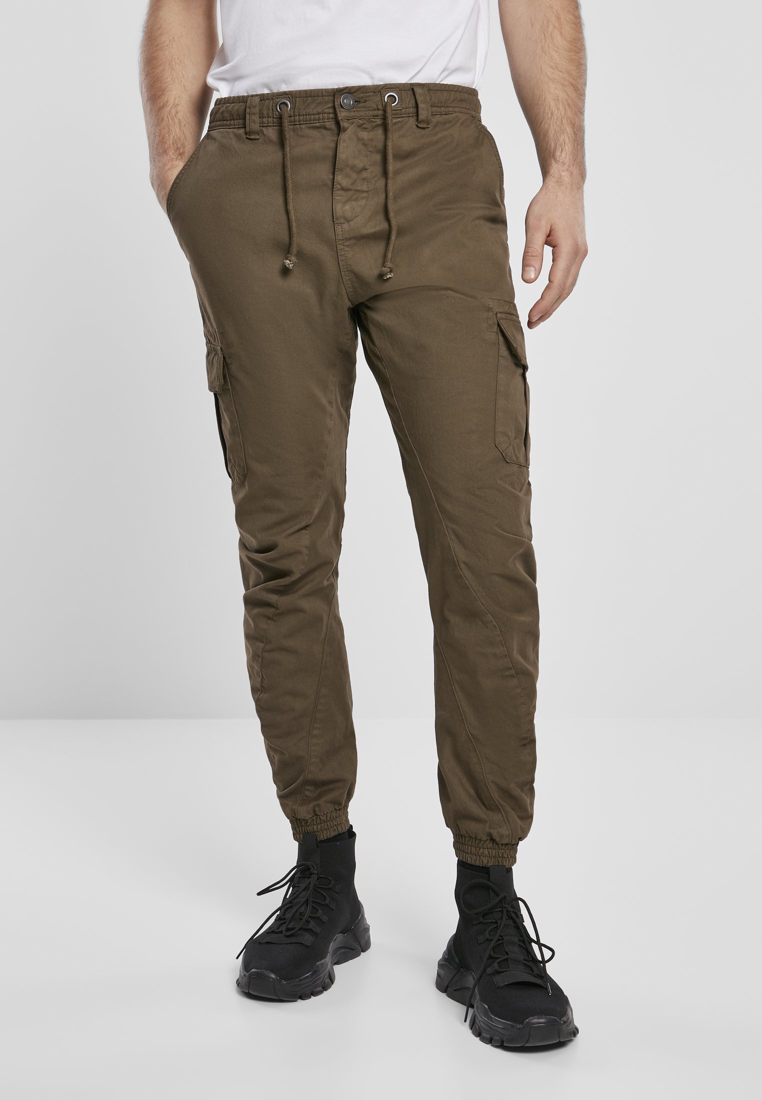 A pair of stylish cargo jogging pants made from 100% cotton, featuring multiple pockets and an elastic waistband for comfort.