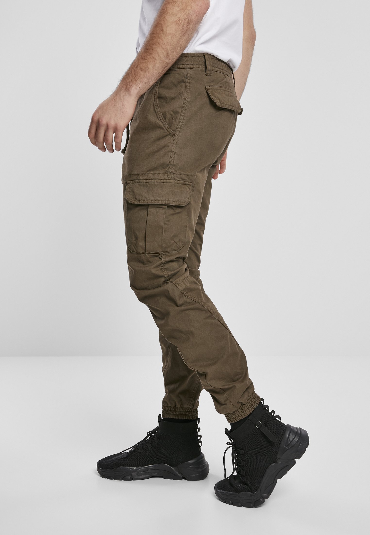 A pair of stylish cargo jogging pants made from 100% cotton, featuring multiple pockets and an elastic waistband for comfort.