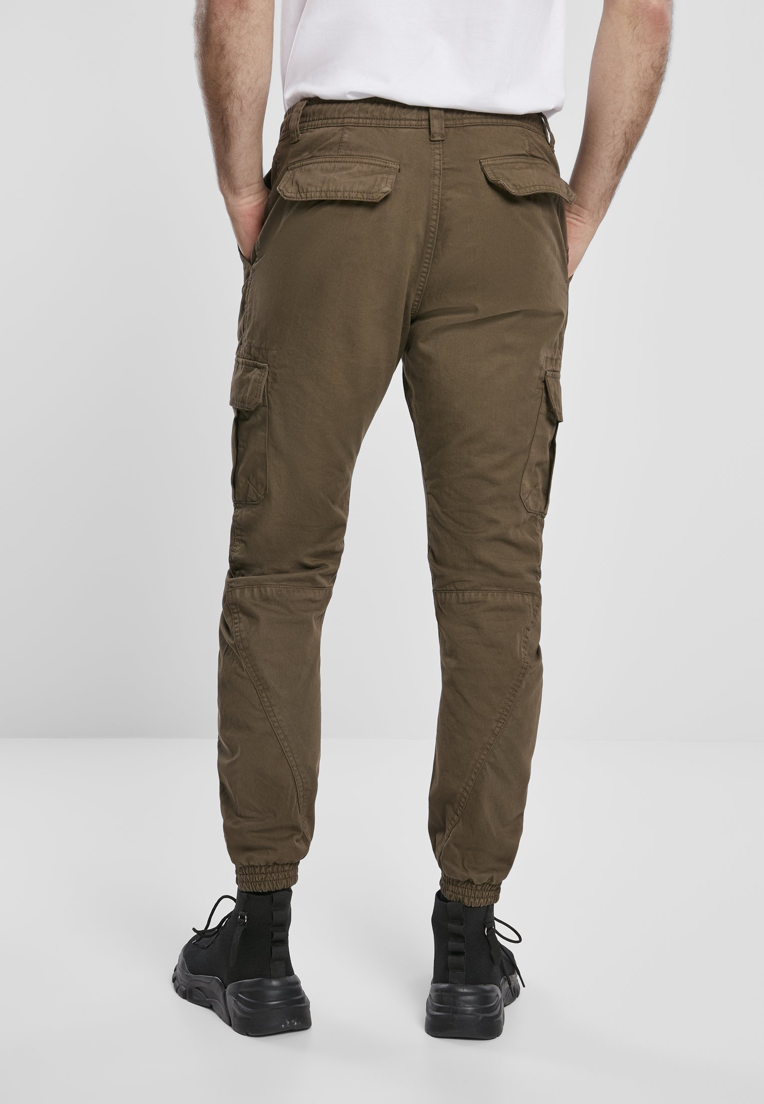 A pair of stylish cargo jogging pants made from 100% cotton, featuring multiple pockets and an elastic waistband for comfort.