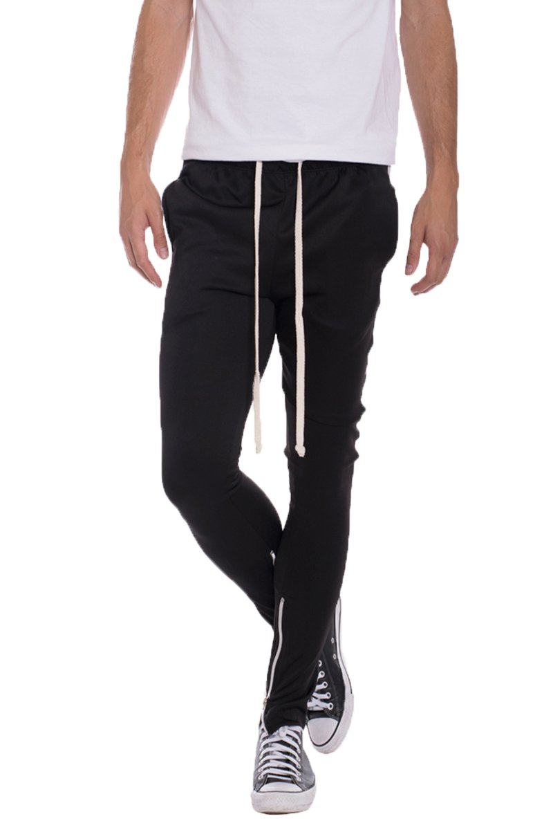 A pair of solid black Diagonal Track Pants featuring a diagonal stripe print on the side, showcasing a skinny fit and elastic waist with drawstring.