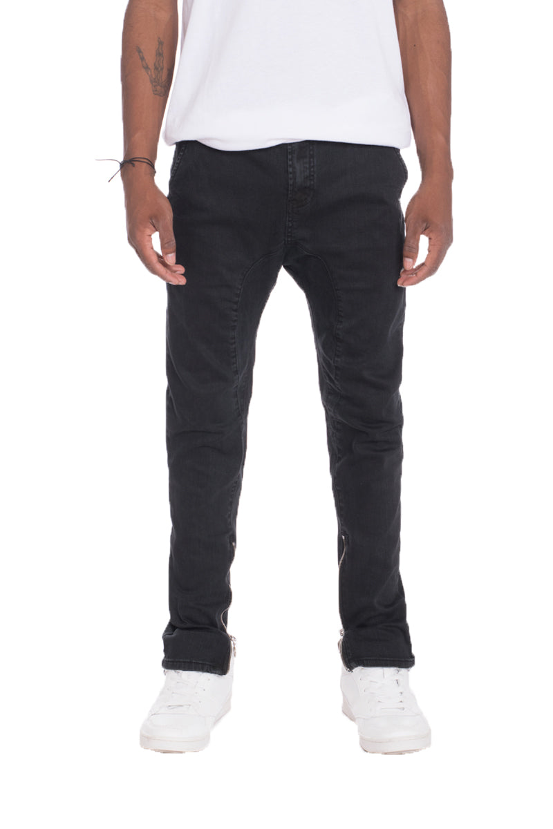 A pair of stylish drop crotch stretch denim jeans featuring a regular fit, standard belt loops, and pockets, made from a soft cotton blend.