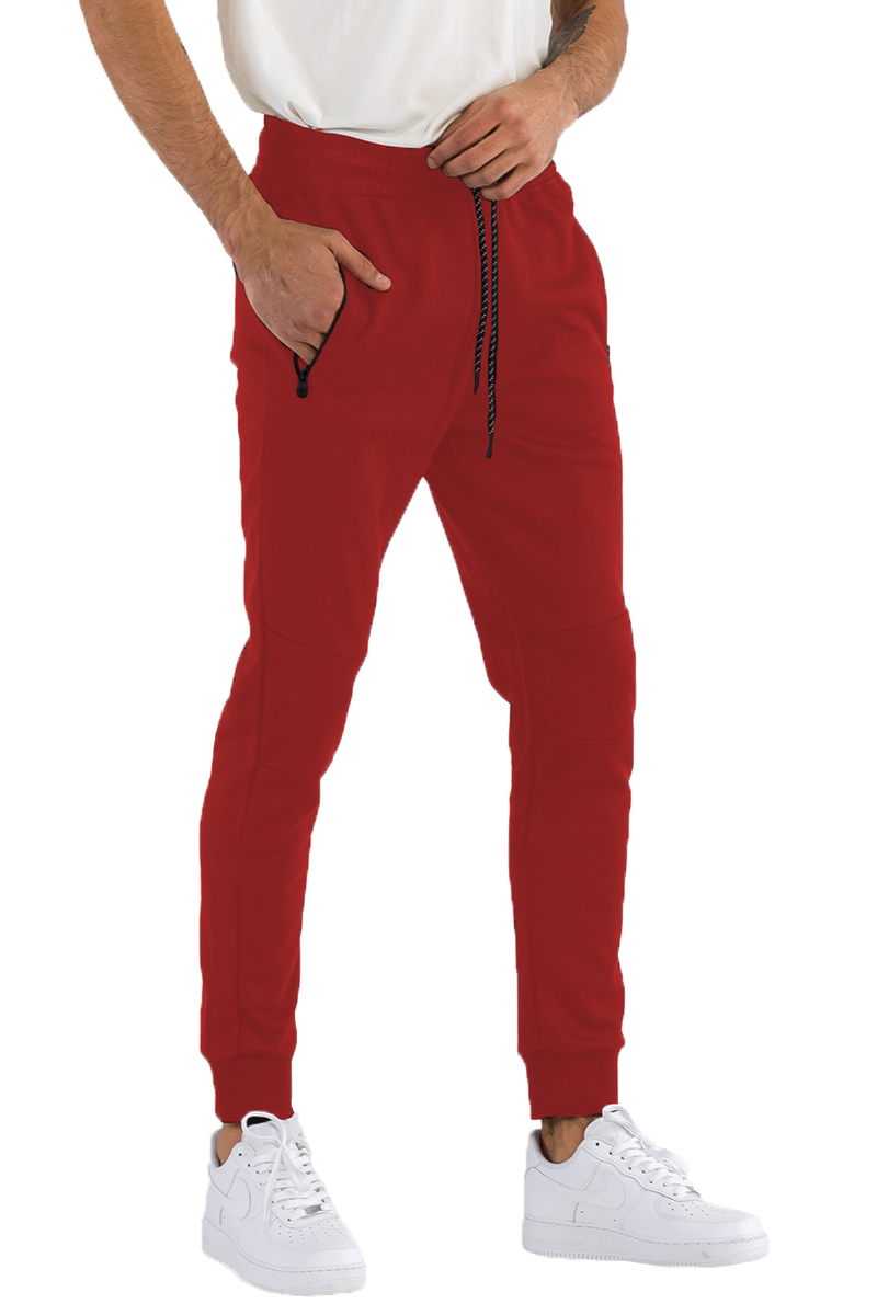 Heathered cotton sweats featuring an elastic waist, ankle cuffs, and a zipper closure front pocket, displayed on a model.