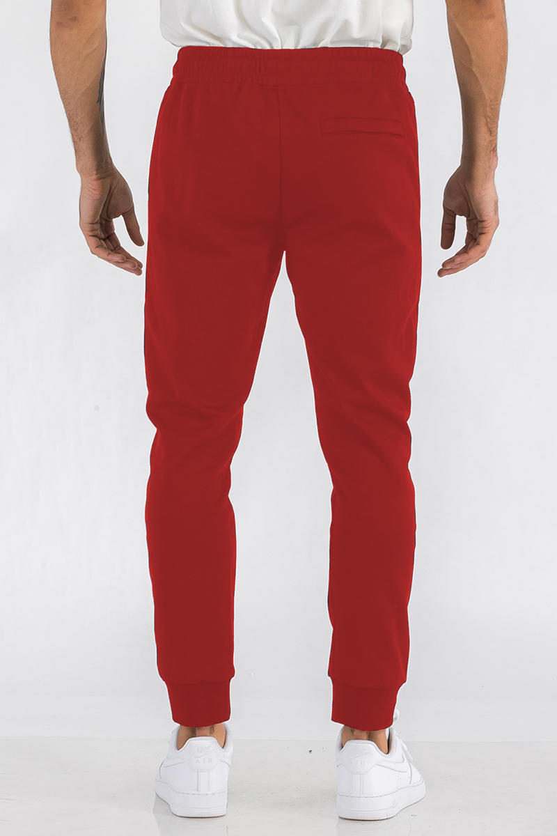 Heathered cotton sweats featuring an elastic waist, ankle cuffs, and a zipper closure front pocket, displayed on a model.