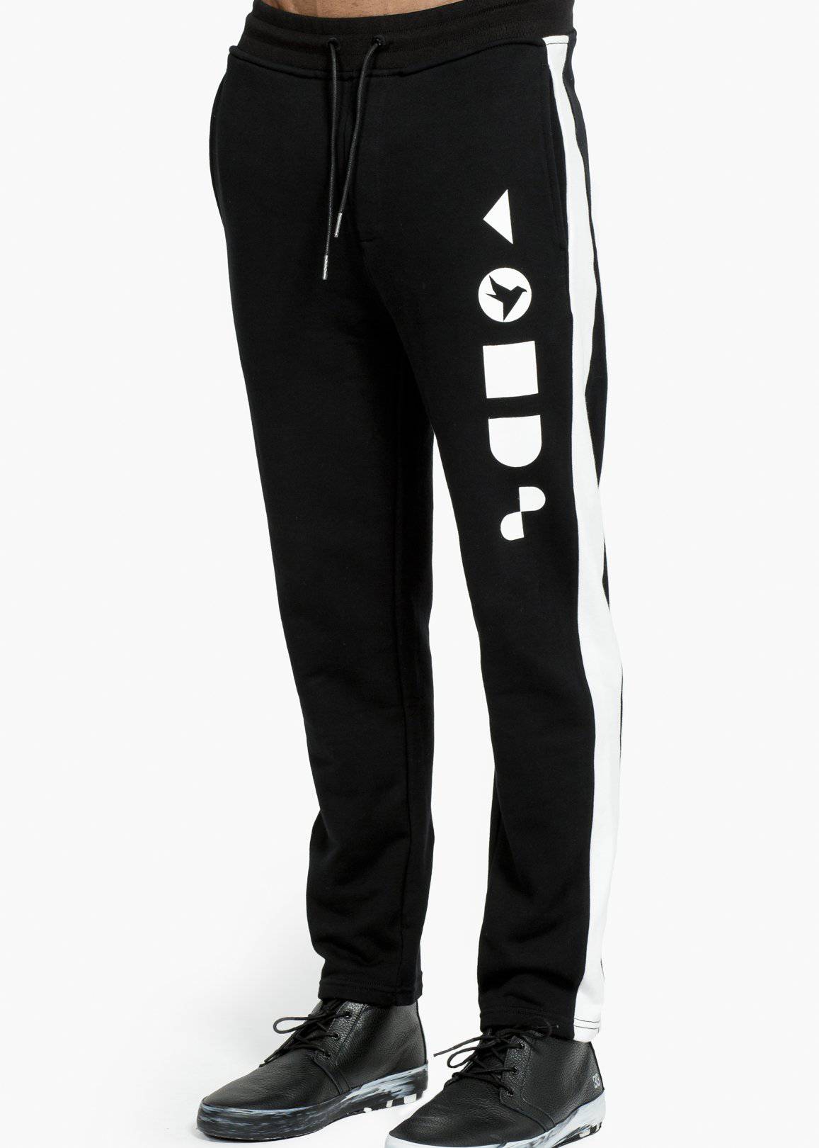 Konus Men's Zip Sweatpants in Black with contrast side panel and vertical print on left thigh, featuring a zipper pocket on the back.