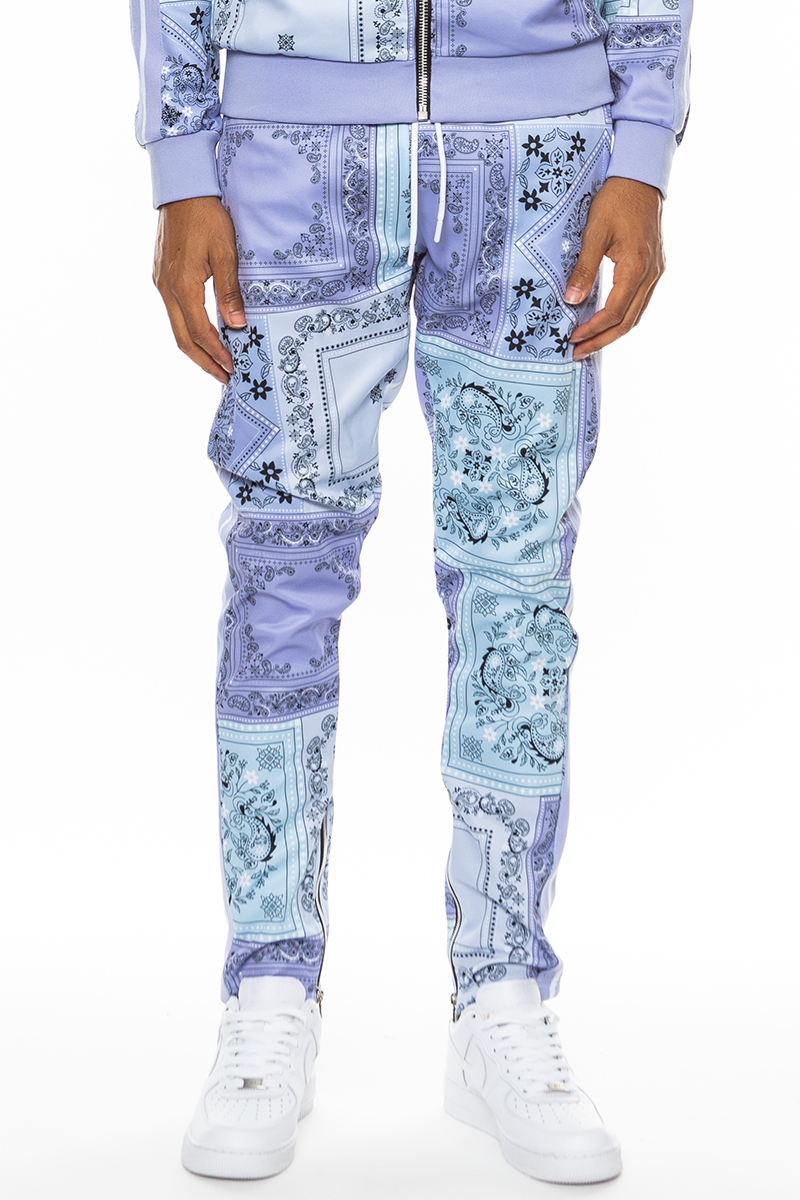 A pair of stylish paisley all over print pants featuring an elastic waist, drawstring, standard pockets, and ankle zippers.