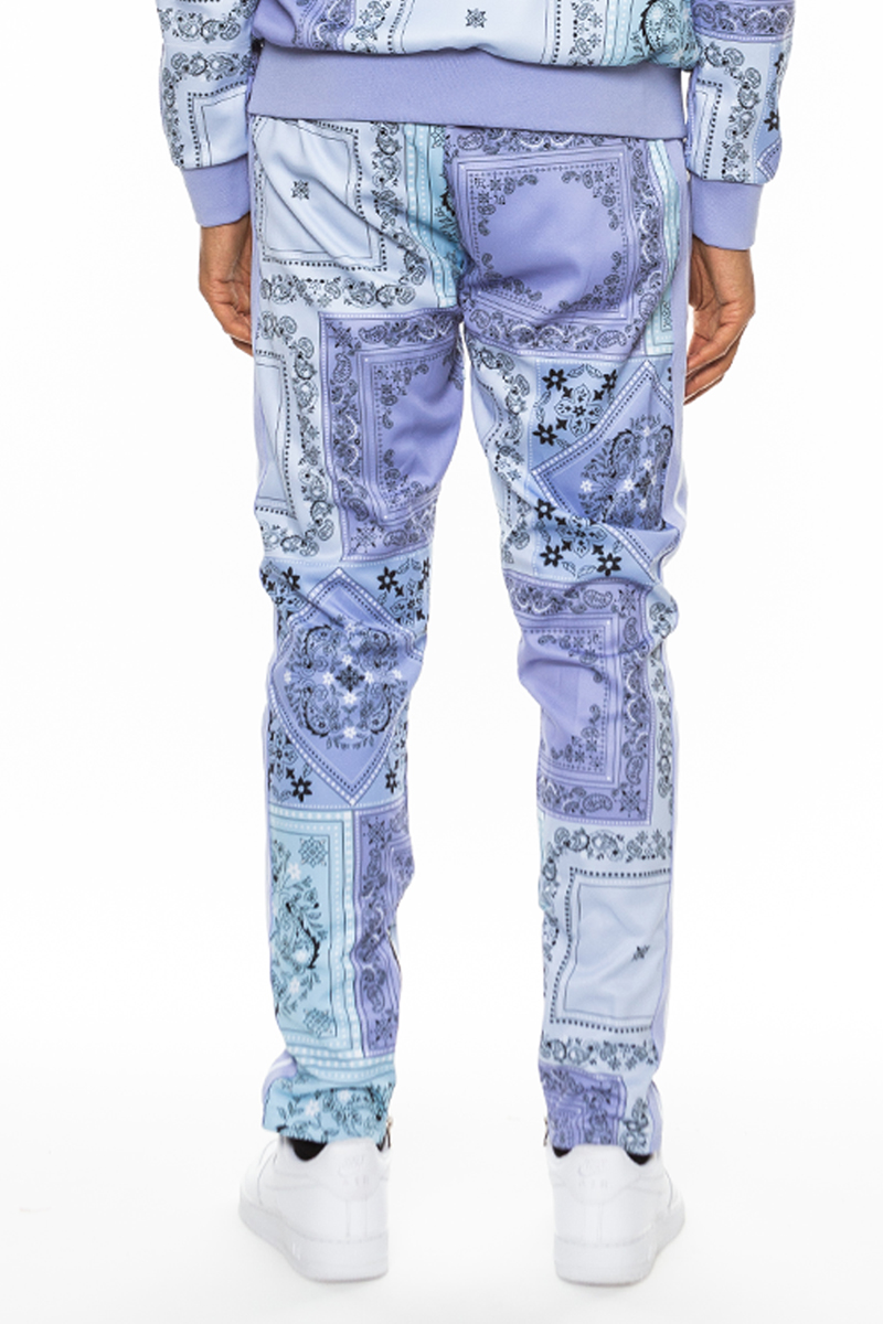 A pair of stylish paisley all over print pants featuring an elastic waist, drawstring, standard pockets, and ankle zippers.