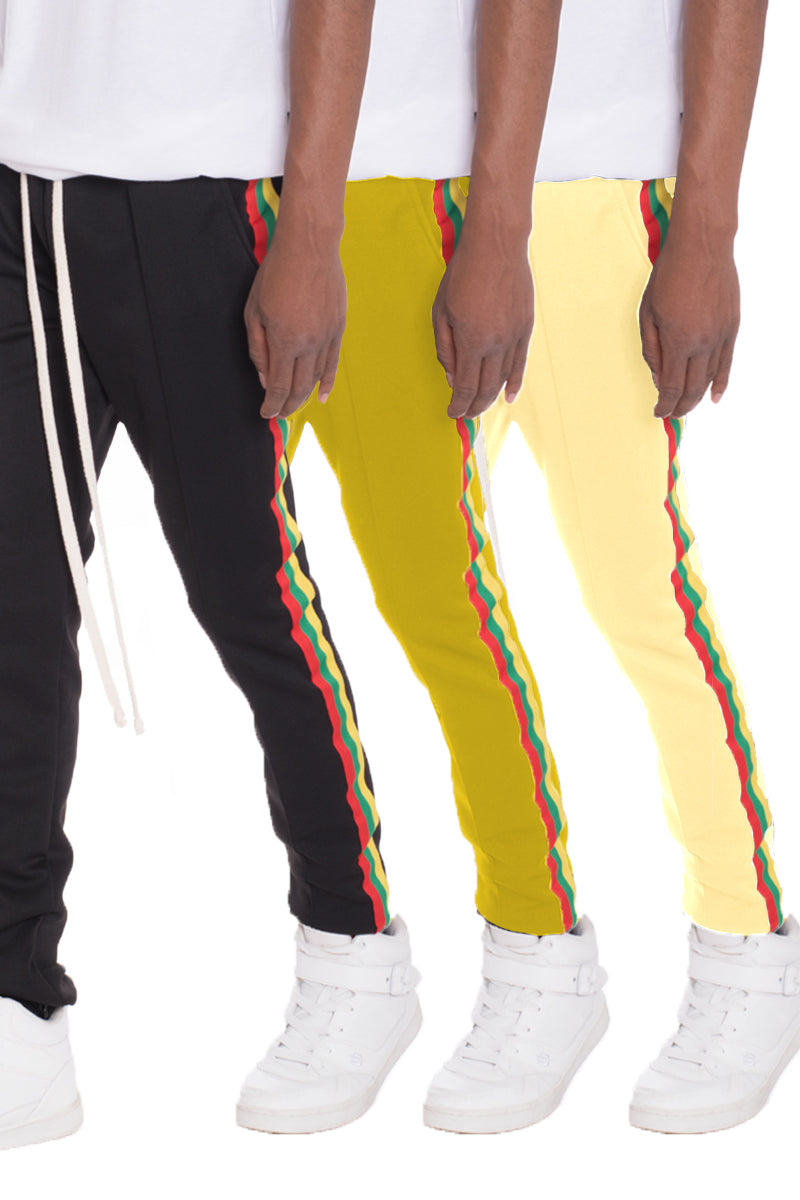 Rasta Track Pants featuring a slim fit, elastic waist, and vibrant red, green, and yellow side tape, perfect for casual and active wear.