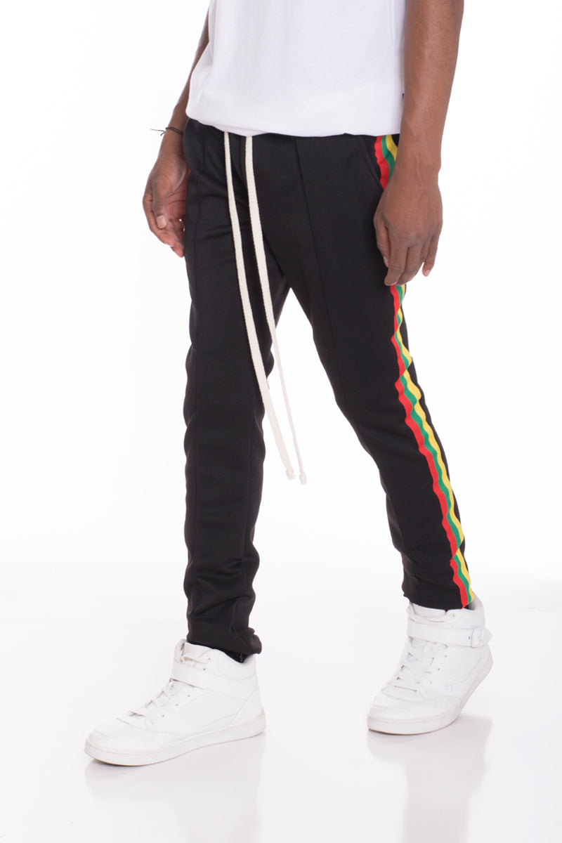 Rasta Track Pants featuring a slim fit, elastic waist, and vibrant red, green, and yellow side tape, perfect for casual and active wear.