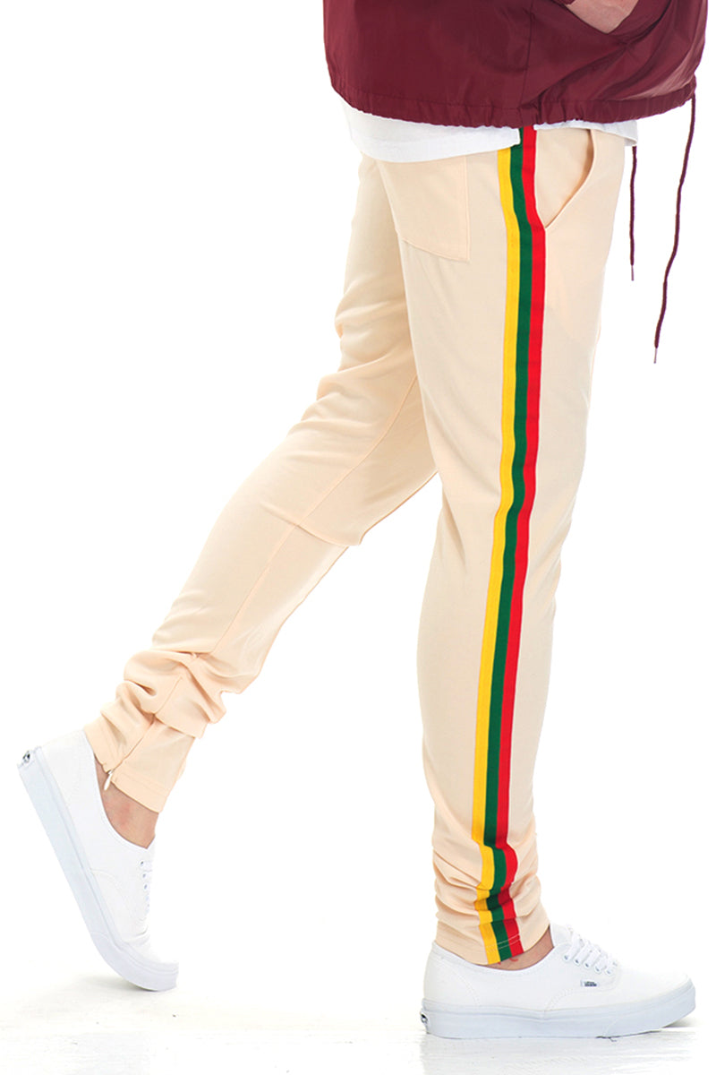 Rasta Track Pants featuring a slim fit, elastic waist, and vibrant red, green, and yellow side tape, perfect for casual and active wear.