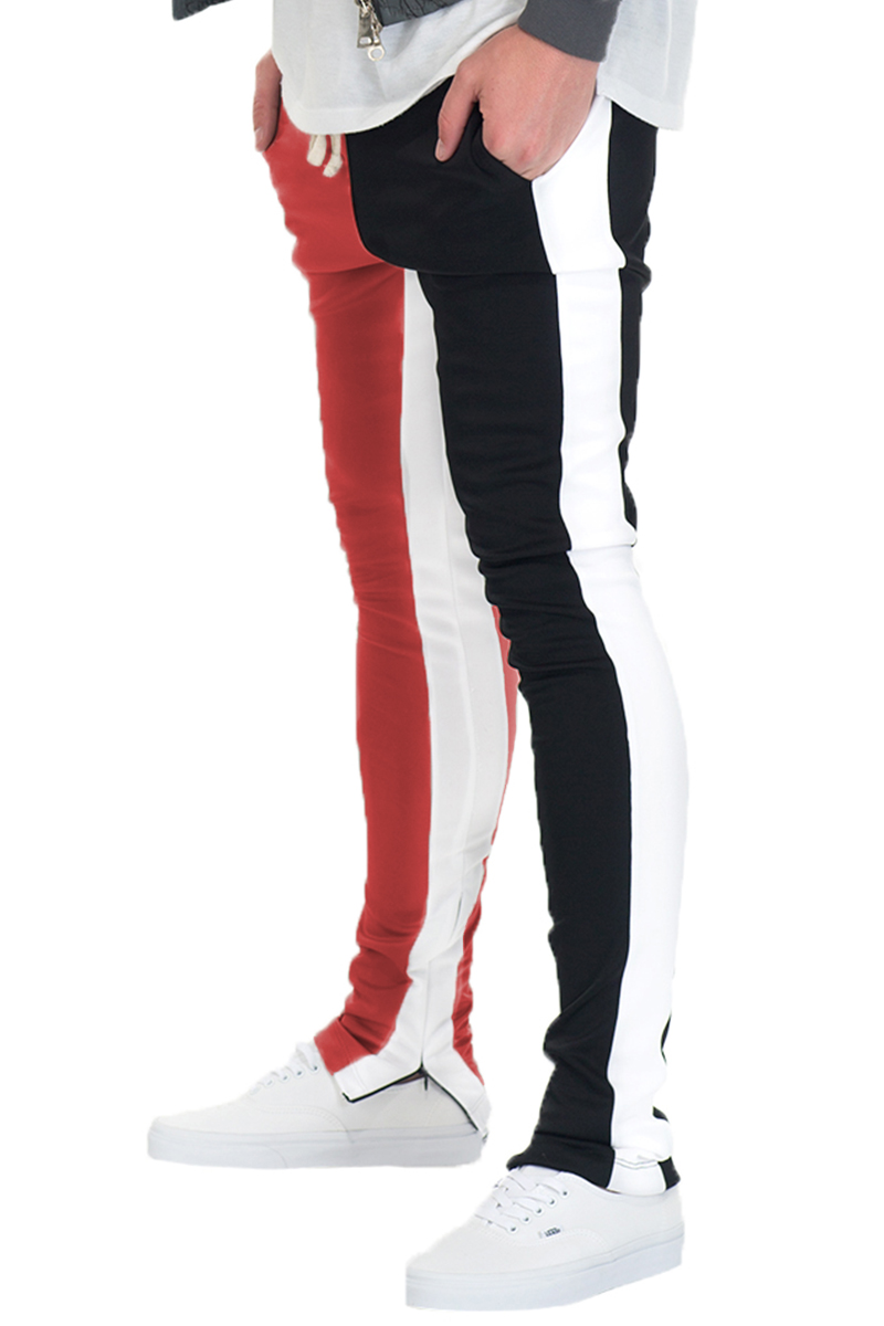 SLICE TRACK PANTS in black and red, featuring an elastic waist, drawstring, and hidden ankle zipper, perfect for workouts and casual wear.