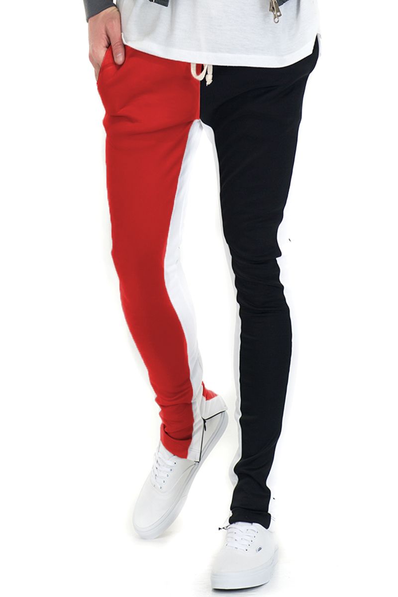 SLICE TRACK PANTS in black and red, featuring an elastic waist, drawstring, and hidden ankle zipper, perfect for workouts and casual wear.