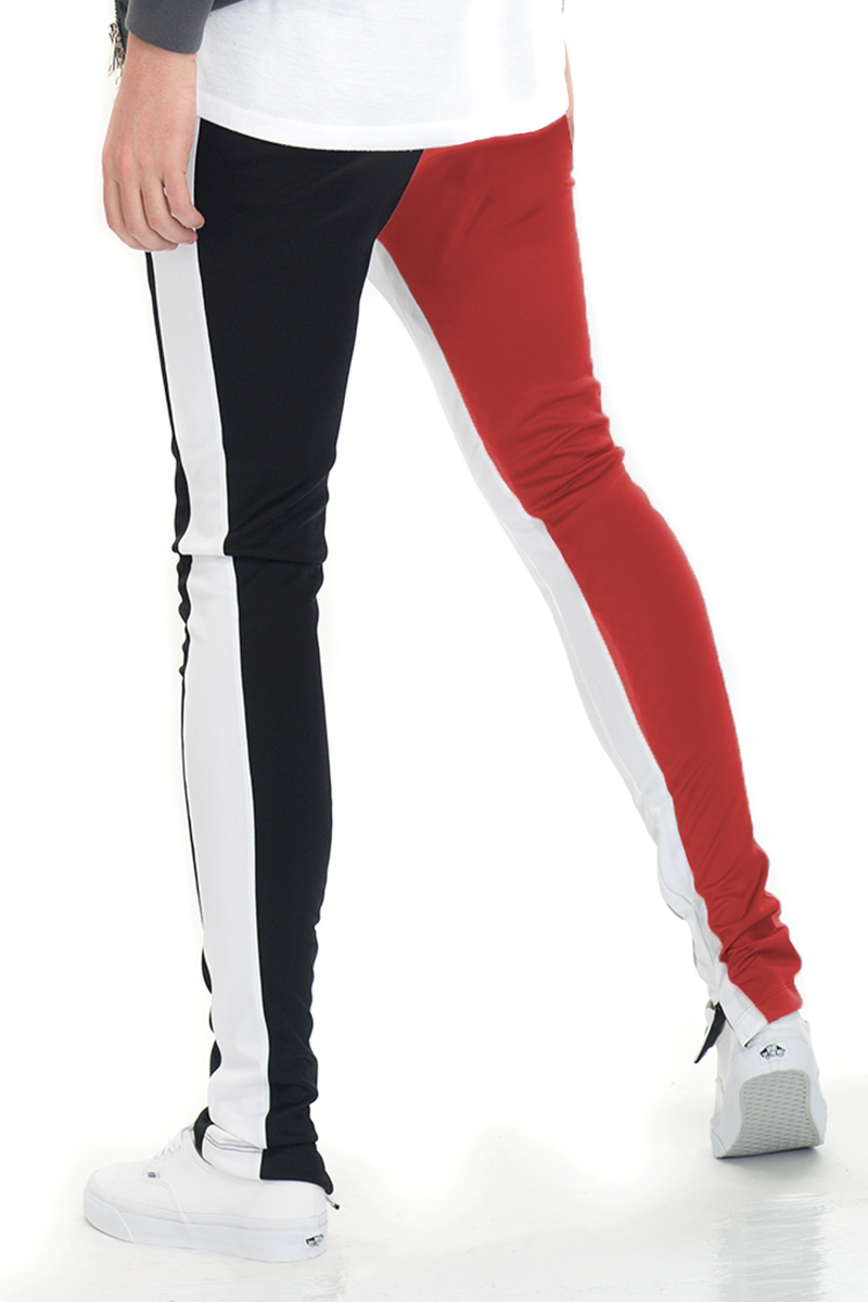 SLICE TRACK PANTS in black and red, featuring an elastic waist, drawstring, and hidden ankle zipper, perfect for workouts and casual wear.