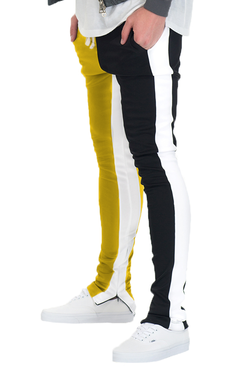 SLICE TRACK PANTS in black and yellow with elastic waist, drawstring, and hidden ankle zipper, perfect for active lifestyles.