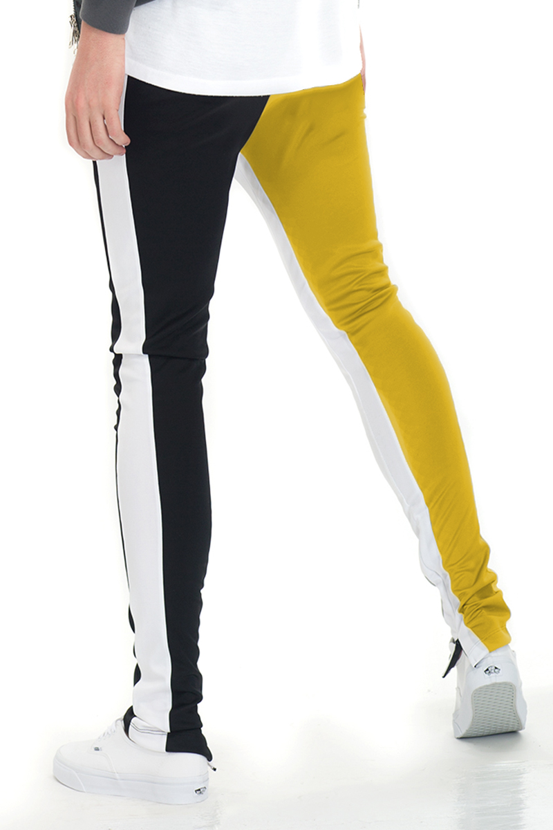 SLICE TRACK PANTS in black and yellow with elastic waist, drawstring, and hidden ankle zipper, perfect for active lifestyles.