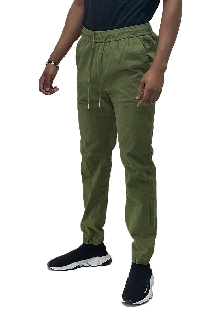 A pair of stylish Solid Jogger Pants featuring an elastic waist and ankle, with standard and back pockets, made from soft cotton blend fabric.