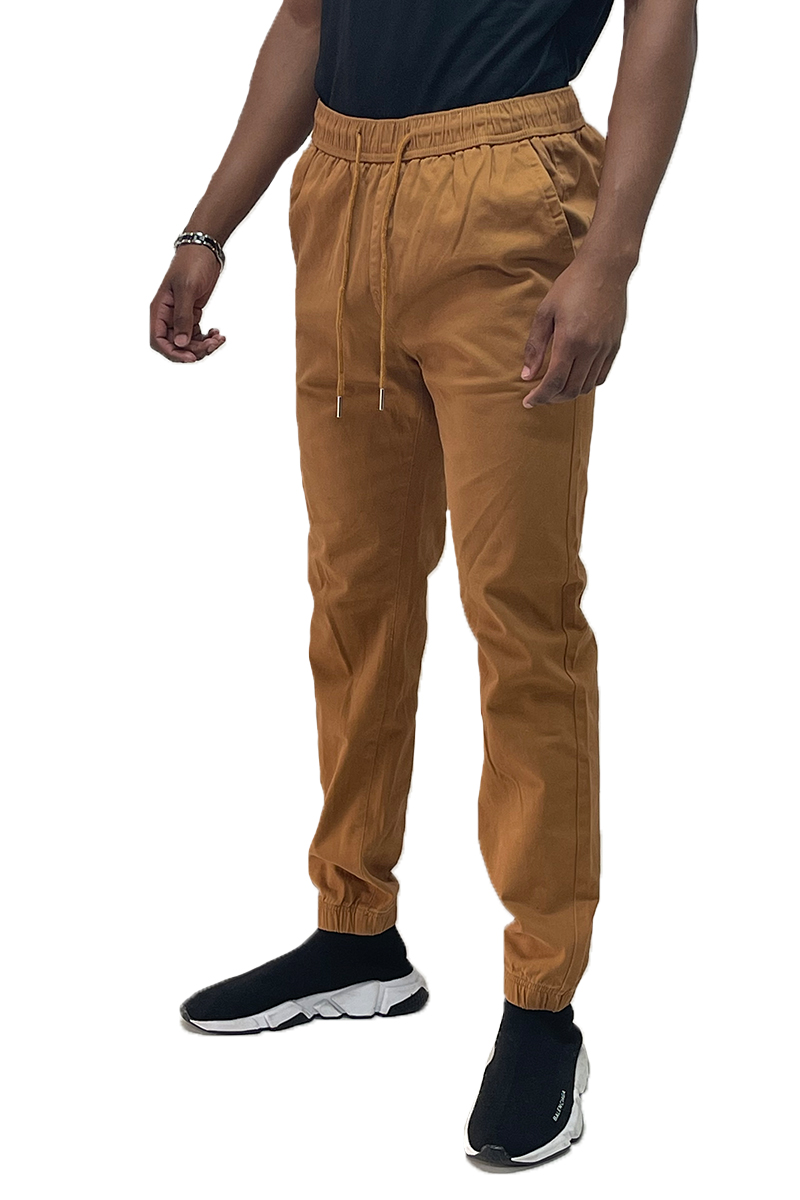 A pair of stylish solid jogger pants featuring an elastic waist and ankle, with standard and back pockets, made from a comfortable cotton blend.