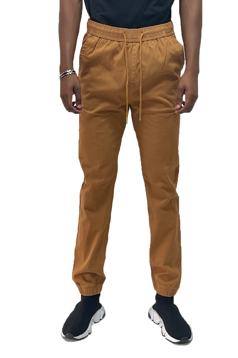 A pair of stylish solid jogger pants featuring an elastic waist and ankle, with standard and back pockets, made from a comfortable cotton blend.