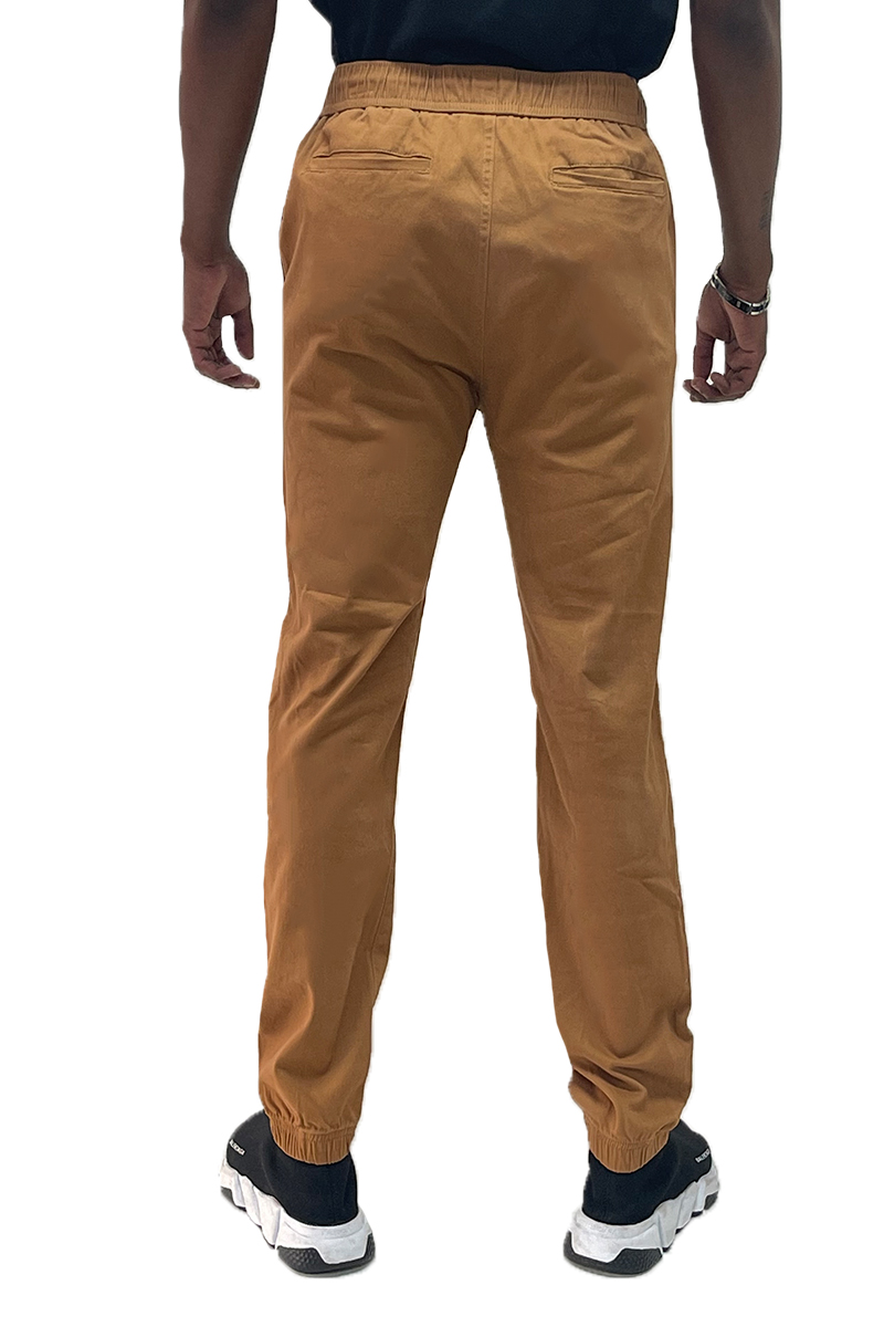 A pair of stylish solid jogger pants featuring an elastic waist and ankle, with standard and back pockets, made from a comfortable cotton blend.