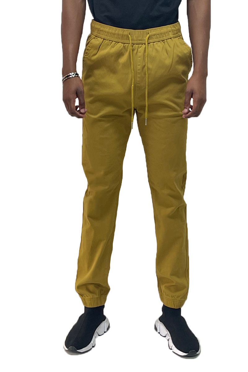 A pair of solid jogger pants featuring an elastic waist band and ankle, with standard and back pockets, made from soft cotton blend fabric.