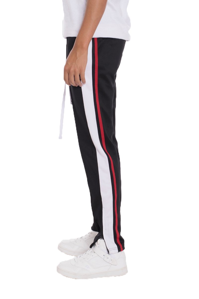 TRICOT Striped Track Pants in Black featuring stylish stripes, front and back pockets, and hidden ankle zippers for a modern look.