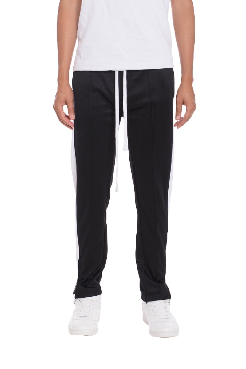 TRICOT Striped Track Pants in Black featuring stylish stripes, front and back pockets, and hidden ankle zippers for a modern look.