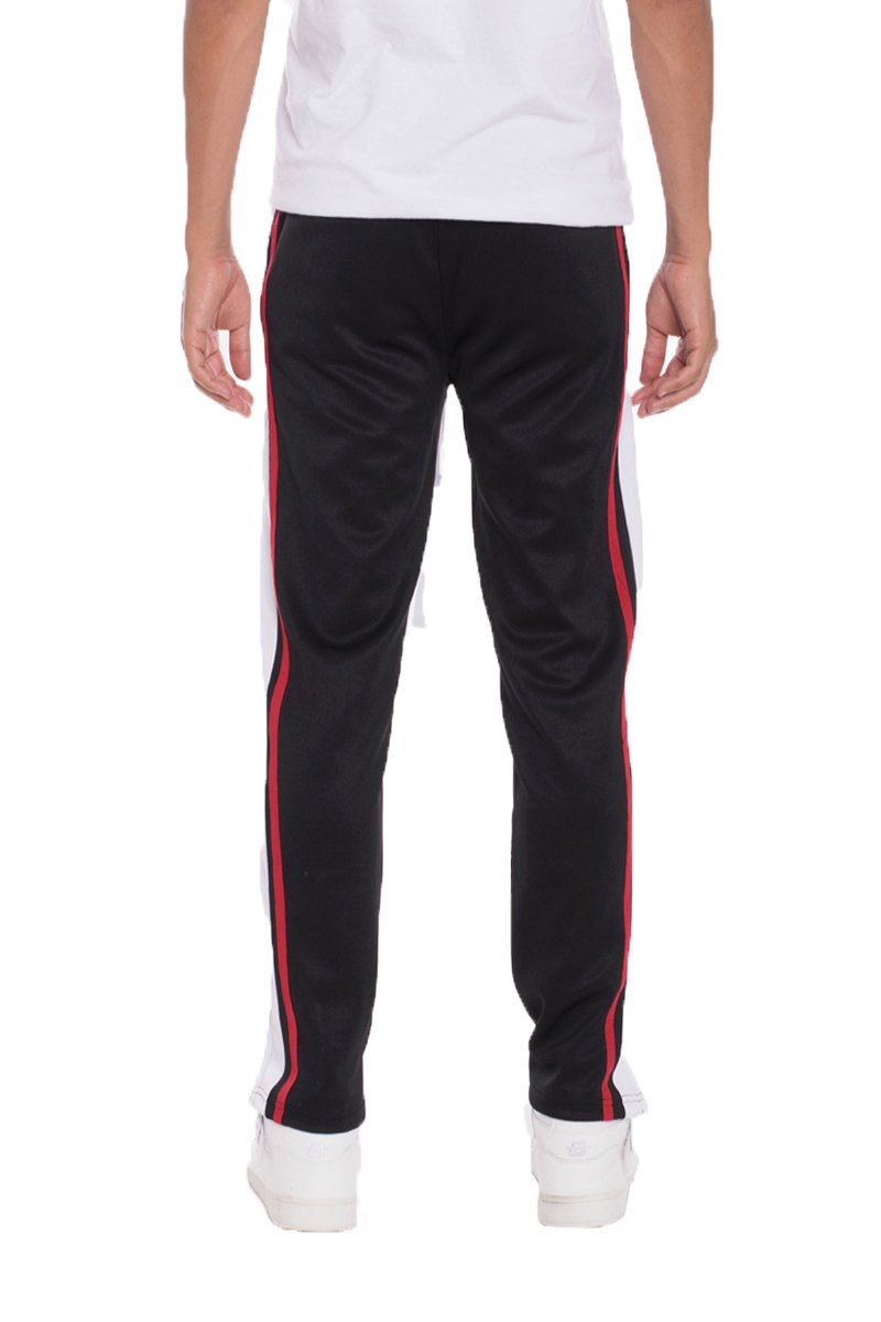 TRICOT Striped Track Pants in Black featuring stylish stripes, front and back pockets, and hidden ankle zippers for a modern look.