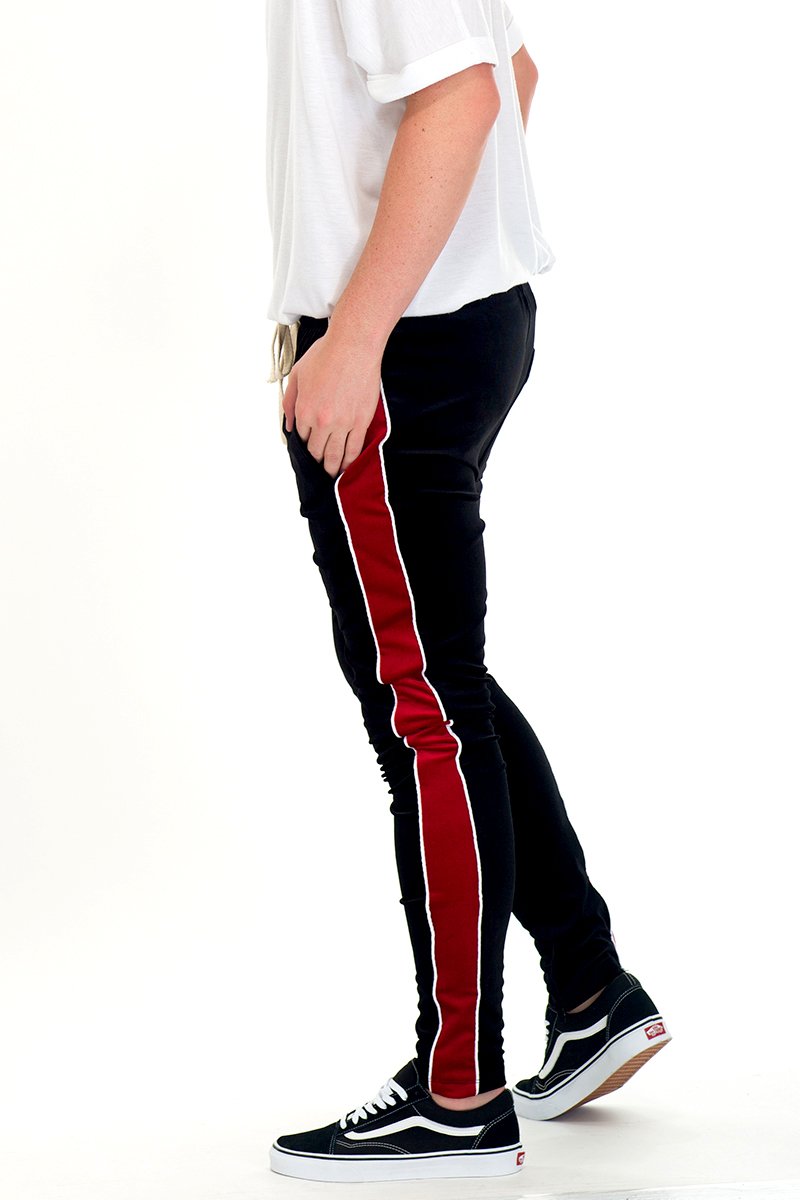 A pair of stylish velvet pants in a rich color, featuring a tug-free zipper and two standard pockets, displayed on a mannequin.