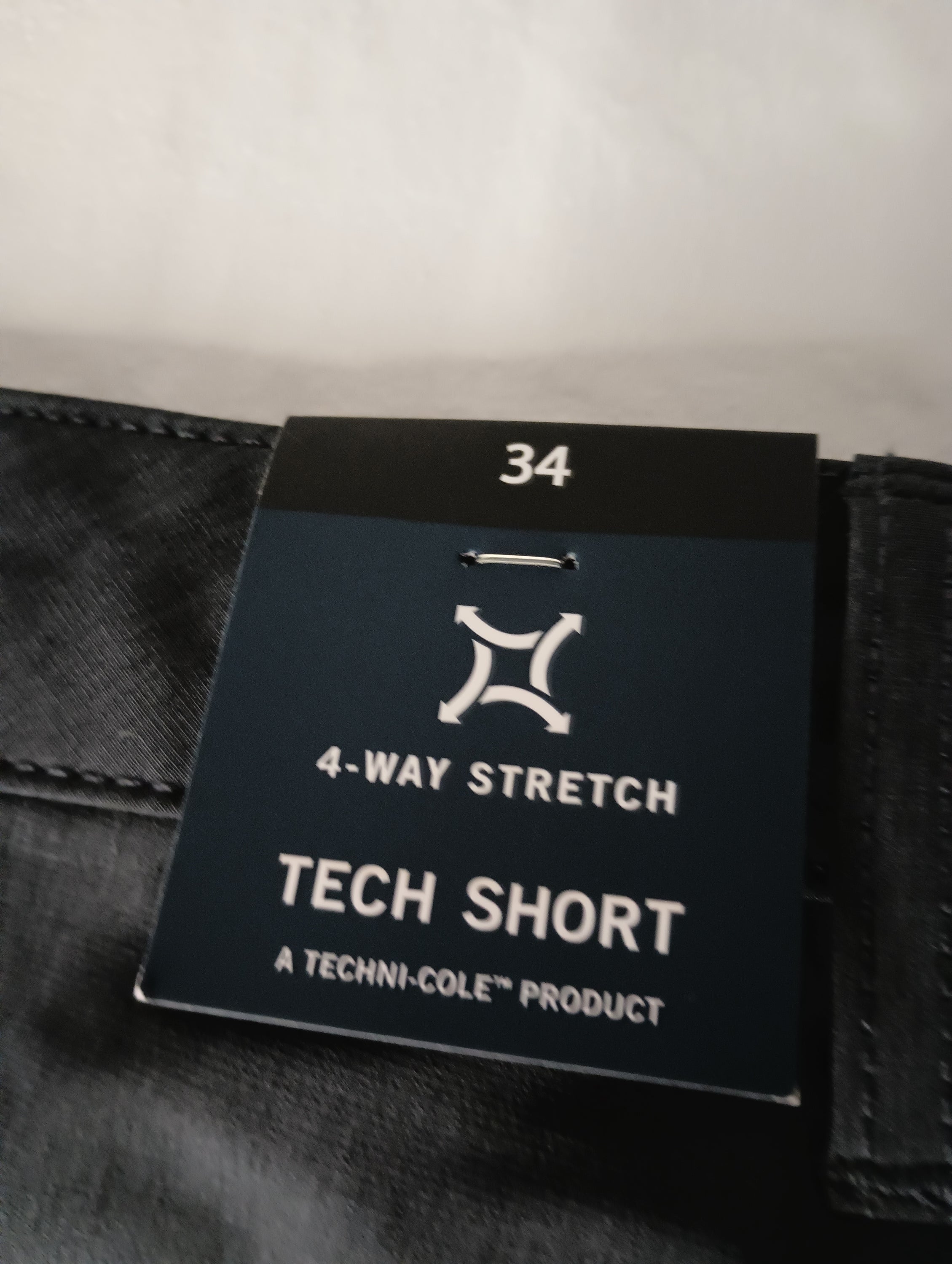 Black Heather Kenneth Cole Tech Shorts in slim fit with hidden pocket and moisture-wicking fabric, perfect for active lifestyles.