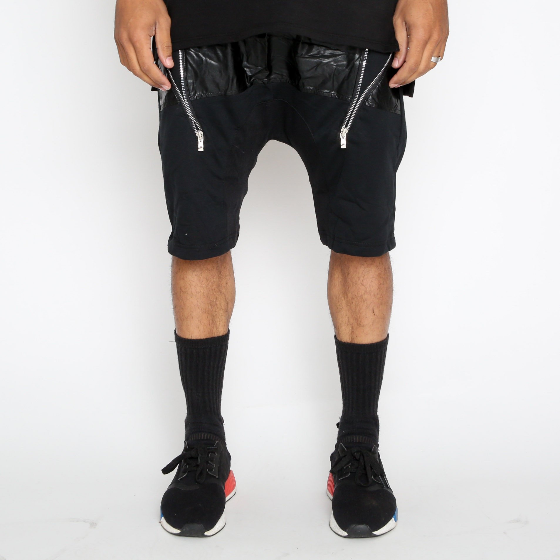 A pair of stylish Leather Front Moto Shorts featuring faux leather material, above-the-knee length, and zipper detail, perfect for streetwear.