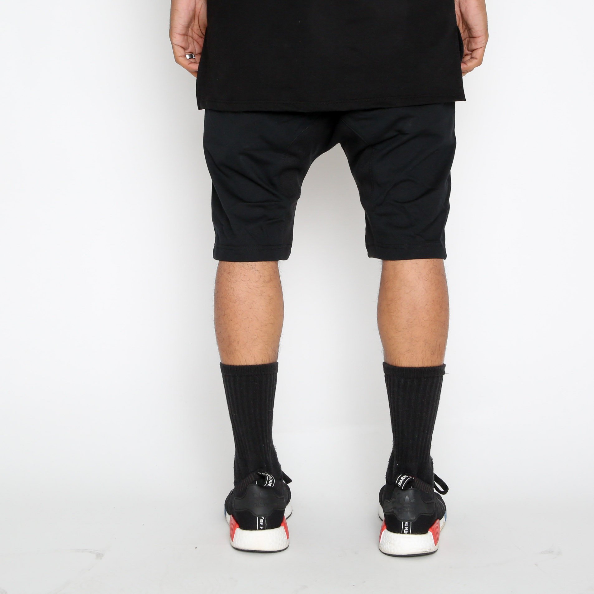 A pair of stylish Leather Front Moto Shorts featuring faux leather material, above-the-knee length, and zipper detail, perfect for streetwear.