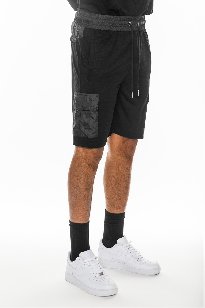 A pair of light weight slub shorts featuring a solid body, elastic waist with drawstring, and a single back pocket, made from 80% cotton and 20% spandex.