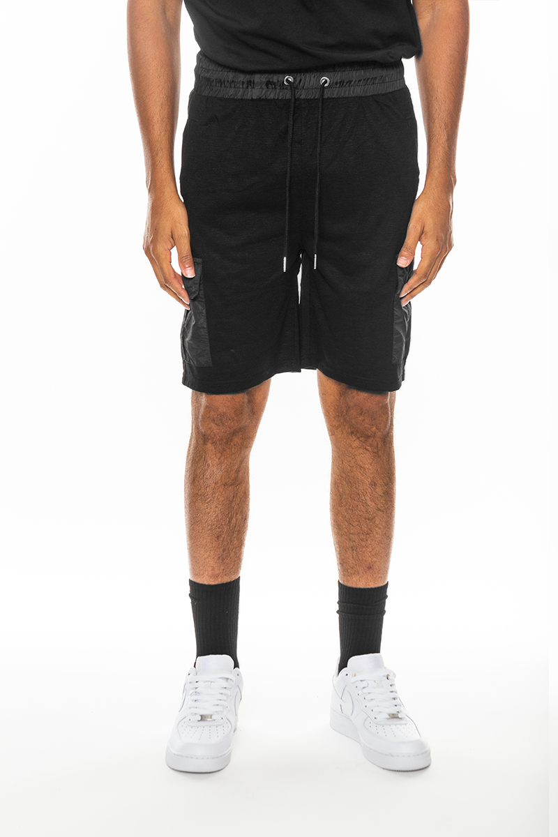 A pair of light weight slub shorts featuring a solid body, elastic waist with drawstring, and a single back pocket, made from 80% cotton and 20% spandex.